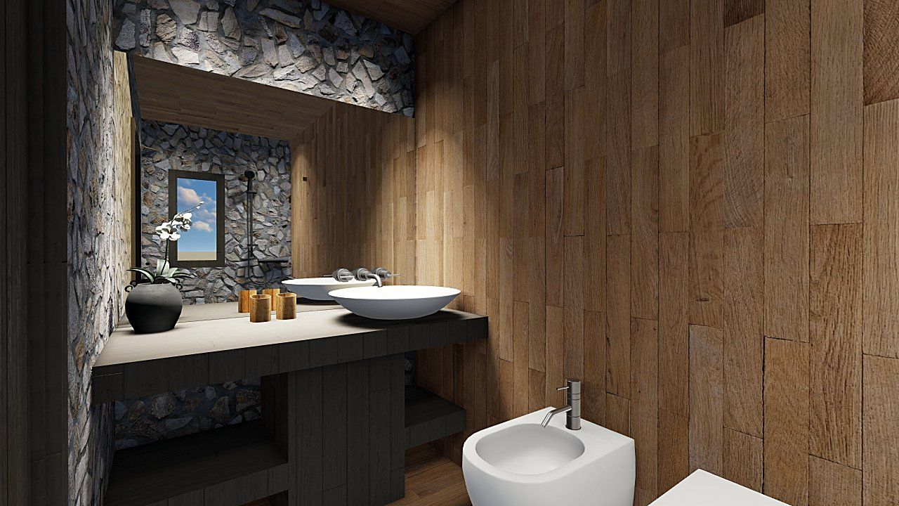 Il lavabo appoggiato sul piano, con la parete in pietra