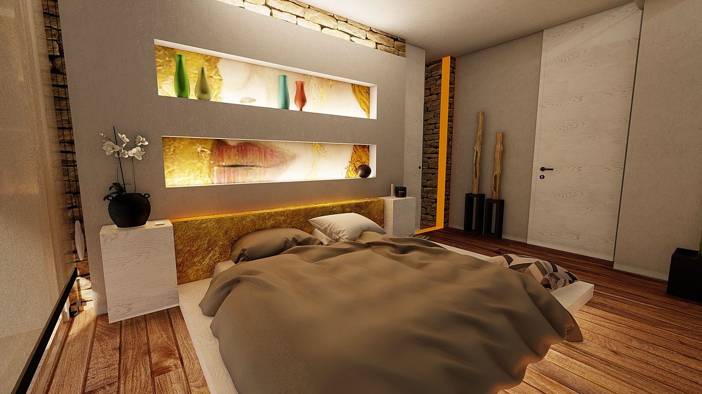 La camera con la nicchia luminosa sopra il letto e il muro di pietra